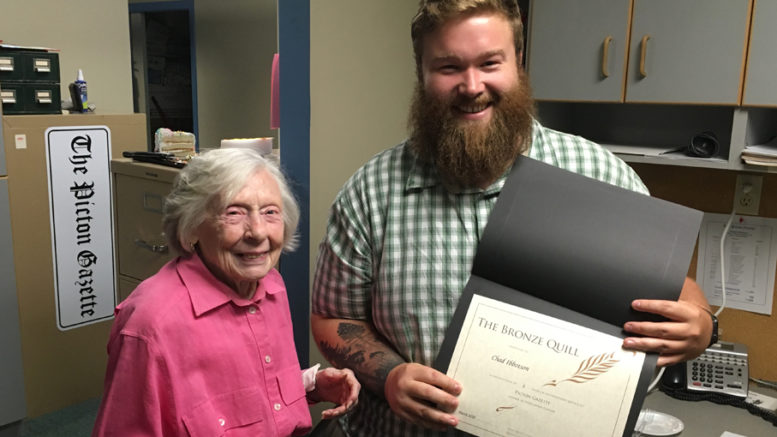 <p>Moving on – Gazette publisher Jean Morrison presents reporter Chad Ibbotson with a Bronze Quill Award from the Ontario Community Newspapers Association in honour of his nine years of service to Prince Edward County readers. Ibbotson is leaving the newspaper to return to school this fall. (Adam Bramburger/Gazette staff)</p>
