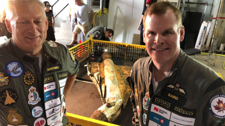 <p>IMPORTANT DISCOVERY- (From Left) Raise the Arrow project leader John Burzynski and former Canadian Foreign Affairs Minister John Baird stand with a recovered delta wing test vehicle at 8 Wing in Trenton last week. (Raise the Arrow photo)</p>
