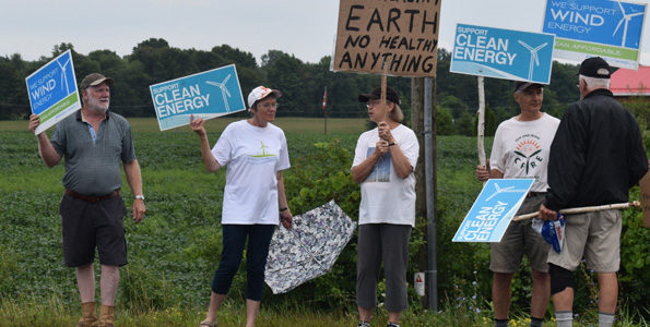 <p>Caught in the wind -Nearly two dozen people upset over the cancellation of the White Pines industrial wind project lined up to jeer Premier Dog Ford at Barley Days Brewery on Tuesday. (Jason Parks/Gazette staff)</p>
