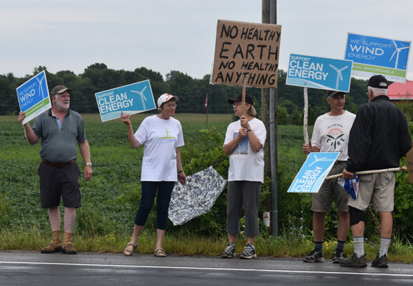 <p>Caught in the wind -Nearly two dozen people upset over the cancellation of the White Pines industrial wind project lined up to jeer Premier Dog Ford at Barley Days Brewery on Tuesday. (Jason Parks/Gazette staff)</p>
