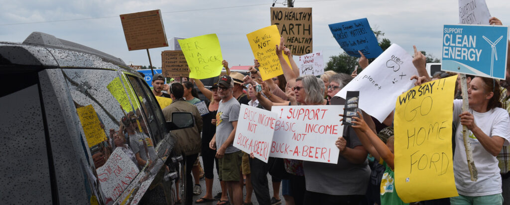<p>Loud and clear -Protesters give departing Ontario Premier Doug Ford a less-than-pleasant send off as he leaves Barley Days Brewery Tuesday morning.  Around 75 people gathered to boo Ford and voice their concerns over the cancellation of the White Pines Wind Project and the government’s direction on climate change, the sexual education curriculum, and the basic income pilot project among other issues. (Jason Parks/Gazette staff)</p>
