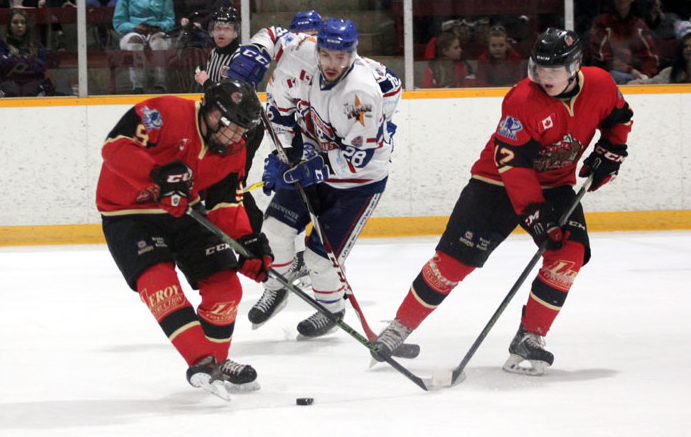 <p>LARGE ADDITION- (Centre) James White, formerly of the Rayside Balfour Canadians of the Northern Ontario Junior Hockey League, in action last season. White was acquired by the Wellington Dukes this week. (NOJHL Photo)</p>
