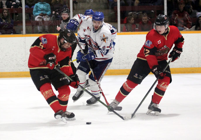<p>LARGE ADDITION- (Centre) James White, formerly of the Rayside Balfour Canadians of the Northern Ontario Junior Hockey League, in action last season. White was acquired by the Wellington Dukes this week. (NOJHL Photo)</p>
