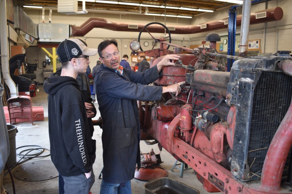 <p>EXPLAINING THE PROCESS- PECI Student Shane Petrie listens to mechanical technology teacher Ted Shepherd on Tuesday morning. Students have begun the process of tearing down and rebuilding a 1953 International Farmall Super M tractor. (Jason Parks/Gazette Staff)</p>
