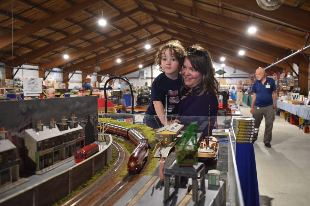 <p>Training on the the trains- Nolan Manley, 3, and his mom Andrea watch a model train travel through the Ottawa British Model Railroad Club layout Saturday afternoon. (Jason Parks/Gazette Staff)</p>
