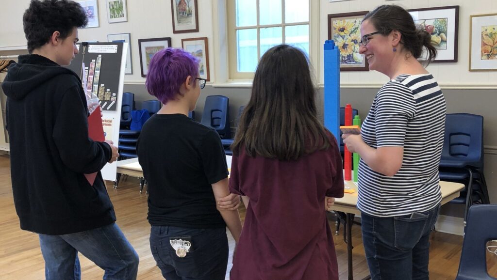 <p>SAVE THE DATA- (Right) Kristin Wheatcroft of the County Foundation speaks with local youth at the Greater Than County Youth Collective data release party at St. Mary Magdalene Hall on Wednesday afternoon. (Submitted Photo)</p>
