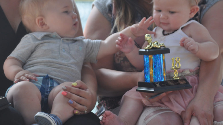 <p>Prized pair – Picton Fair baby show winner Tyler Jeffery Mulder, left, and runner-up Iyla Grace Anne Stefankiewicz share a moment during the final round of judging at the Crystal Palace Friday. (Adam Bramburger/Gazette staff)</p>
