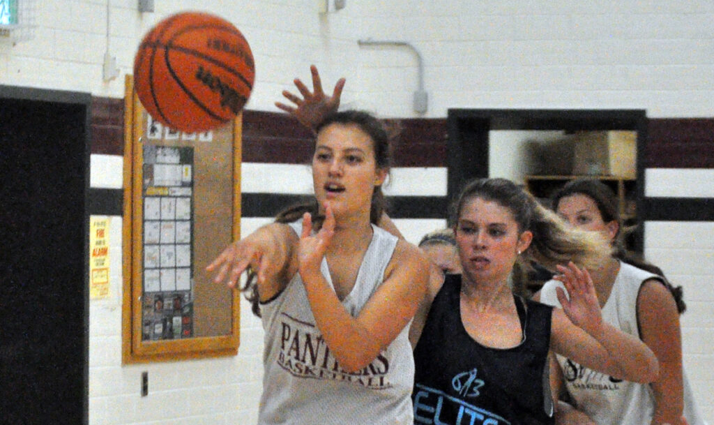 <p>Quick movements – Jessie Swackhammer, left, tosses the ball outside of the key amid tight defence by Emma Lamorre. Both returning vets will be counted on to lead the Panthers this season. (Adam Bramburger/Gazette staff)</p>
