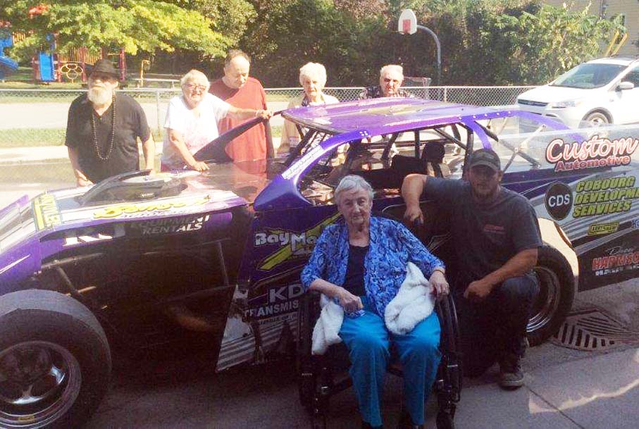 <p>Brighton Speedway dirt champion Andrew Hennessey recently visited Kentwood Park Nursing Home to show excited residents his stock car. Hennessey was kind enough to pose for photos with any resident who asked and he also revved up his engine to  let them hear how loud it could go.  (Submitted photo)</p>
