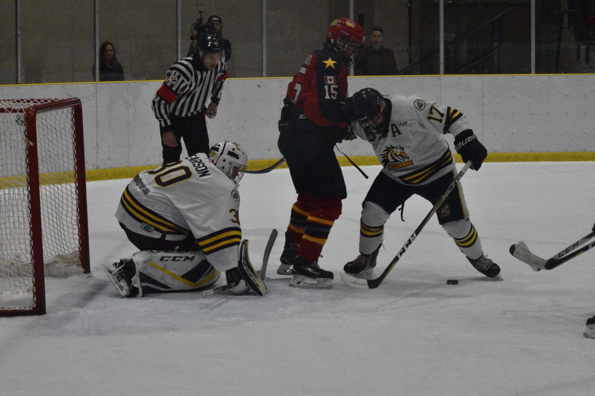 <p>ALL EYES ON ME- Whitby Fury defenceman Amedeo Mastrangelli and netminder Luke Pearson keep an eye on the puck underneath the skates of Wellington Duke Andrew Rinaldi as OHA official Justin Kuipers looks on. Wellington was shut out on home ice by the visiting Fury 4-0 Friday. (Jason Parks/Gazette Staff)</p>
