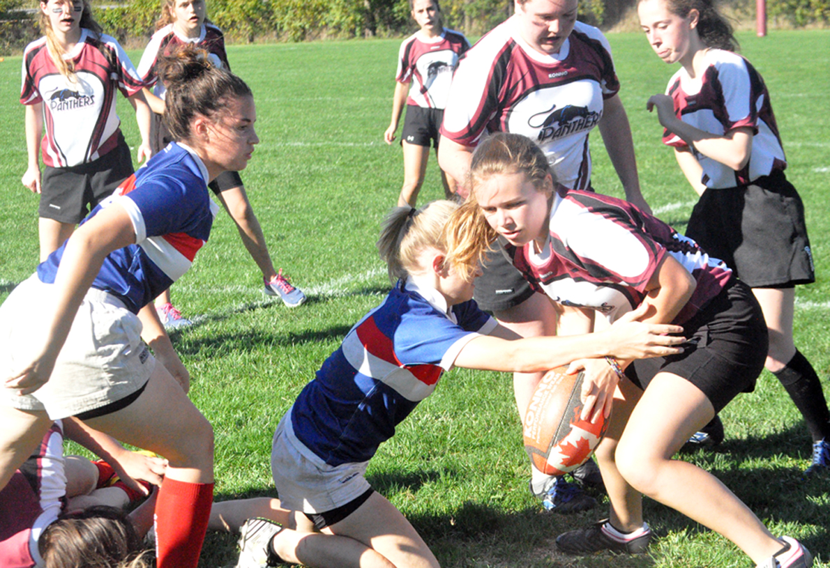 <p>PECI Panthers ball carrier Ally Johnston tries to push for a bit more territory in a ruck against the St. Paul Falcons with teammates Brynn Peck and Elle Ball in support Thursday afternoon. The Panthers, who are running a varsity team at the senior level picked up their first try of the season in the loss PECI was to wrap up the Bay of Quinte Conference regular season after press time yesterday at Centre Hastings.  (Adam Bramburger/Gazette staff)</p>
