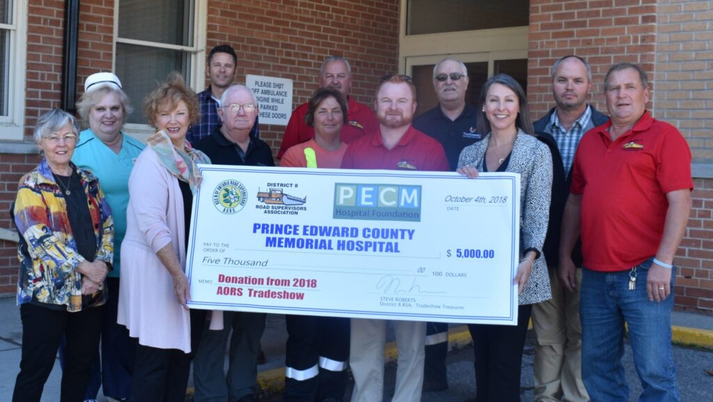 <p>ROAD WORK- A public works trade show in Belleville earlier this year has netted funds for five hospitals in southeastern Ontario. On Thursday, District 8 of the Association of Ontario Road Supervisors presented the Prince Edward County Memorial Hospital Foundation with a cheque for $5,000. Pictured here from left, Fran Donaldson, director on the PECMH Foundation Board, Cheryl Minaker, RN and team leader in the PECMH Emergency Department, Barbara McConnell, vice chair of the Foundation, Leon Quaiff, retired roads supervisor with PE County, Mike Fraser, equipment supervisor for the County of Prince Edward, Sharon Green with the City of Belleville Road Patrol, Ron Vankoughnet, public works supervisor for Greater Napanee, Joe Reid, President of AORS and with the roads department with the City of Belleville, Pat Heffernan, Operations Supervisor for the County of Prince Edward, Shannon Coull, executive director for the PECMH Foundation, Preston Parkinson, Director of Operations for the County of Prince Edward and John Farrell, roads supervisor for Tyendinaga Township.  (Jason Parks/Gazette Staff)</p>
