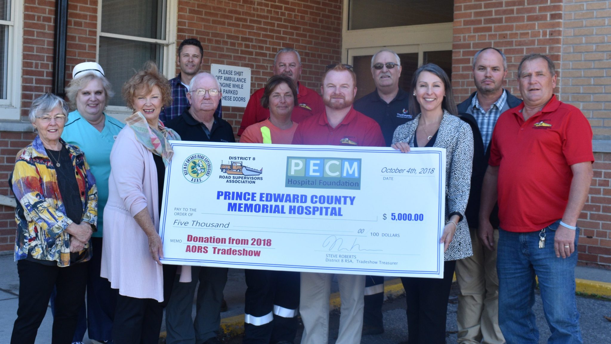 <p>ROAD WORK- A public works trade show in Belleville earlier this year has netted funds for five hospitals in southeastern Ontario. On Thursday, District 8 of the Association of Ontario Road Supervisors presented the Prince Edward County Memorial Hospital Foundation with a cheque for $5,000. Pictured here from left, Fran Donaldson, director on the PECMH Foundation Board, Cheryl Minaker, RN and team leader in the PECMH Emergency Department, Barbara McConnell, vice chair of the Foundation, Leon Quaiff, retired roads supervisor with PE County, Mike Fraser, equipment supervisor for the County of Prince Edward, Sharon Green with the City of Belleville Road Patrol, Ron Vankoughnet, public works supervisor for Greater Napanee, Joe Reid, President of AORS and with the roads department with the City of Belleville, Pat Heffernan, Operations Supervisor for the County of Prince Edward, Shannon Coull, executive director for the PECMH Foundation, Preston Parkinson, Director of Operations for the County of Prince Edward and John Farrell, roads supervisor for Tyendinaga Township.  (Jason Parks/Gazette Staff)</p>
