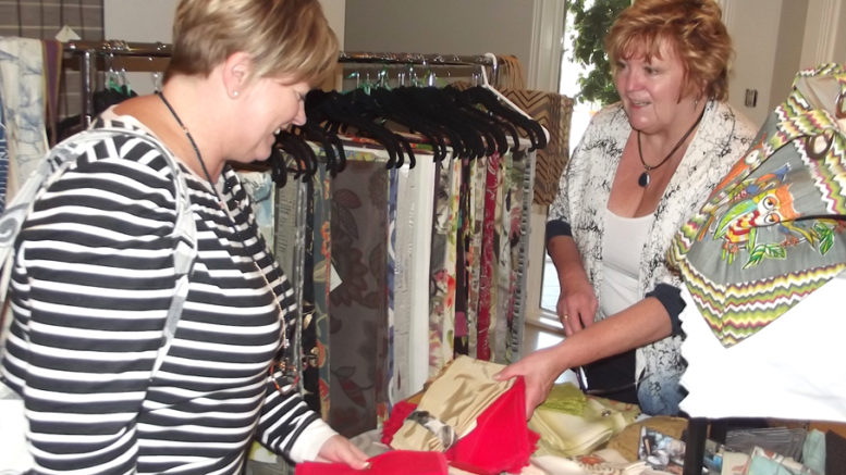 <p>Examining the goods  -Nancy Stroud, left, of Belleville was examining sets of napkins made by Jill Artibello, right, of Seasons & Occasions of Peterborough during the annual craft sale on Saturday (Terry McNamee/For The Gazette)</p>
