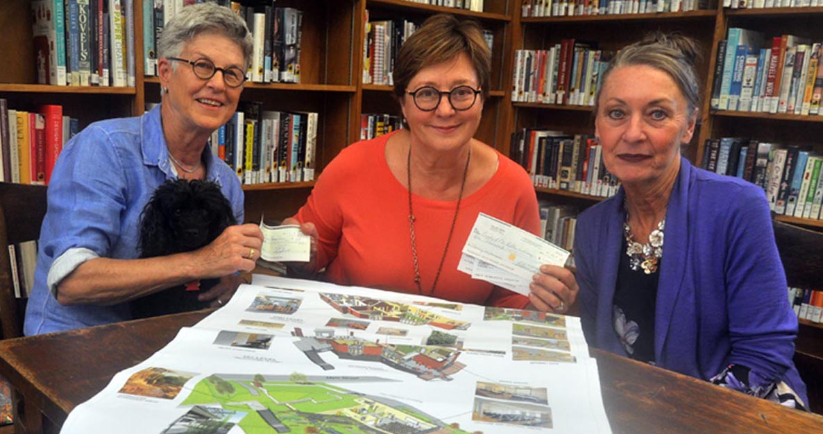 <p>Every dollar counts -Elizabeth Etue, left, hands a donation to the Picton library branch expansion project to fundraising committee chair Alexandra Bake, centre, and the County Library’s chief executive officer Barbara Sweet. Thanks to an anonymous donor, any gift to the campaign made in the month of October will be matched dollar-for-dollar up to a maximum amount of $100,000.  (Adam Bramburger/Gazette staff)</p>
