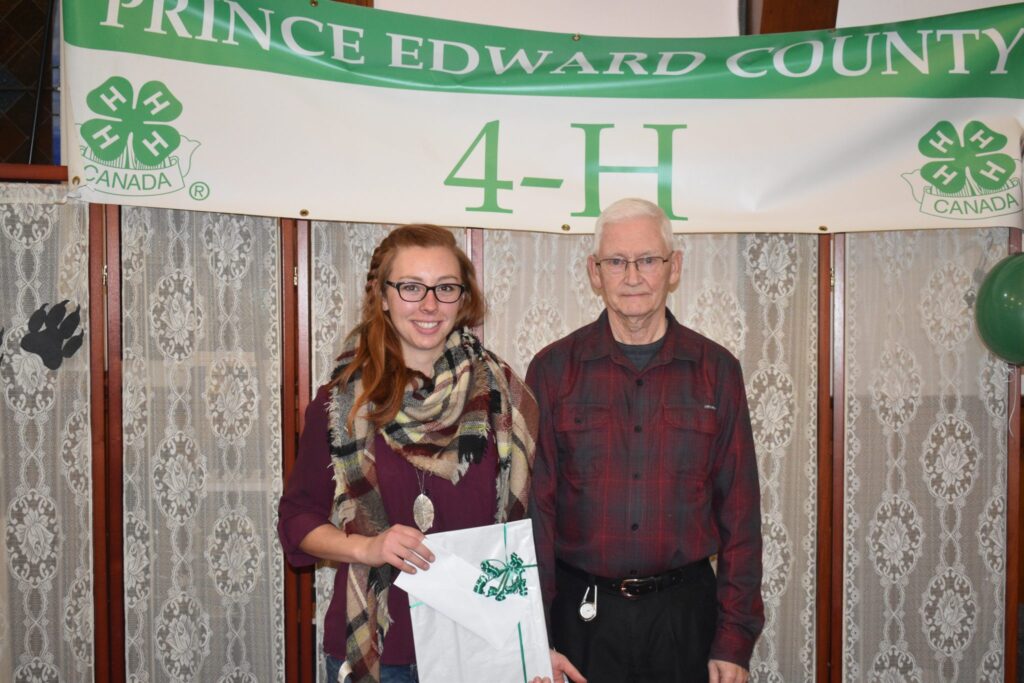 <p>TOP AGRICULTURAL MEMBER- Beef Club and Giant Pumpkin and Vegetable Club member Emily Norton accepts the Ontario Plowmen’s Association Award from 4-H Association president Gaye Insley at the group’s annual awards program Friday night at the Hope Centre in Picton. (Jason Parks/Gazette Staff)</p>
