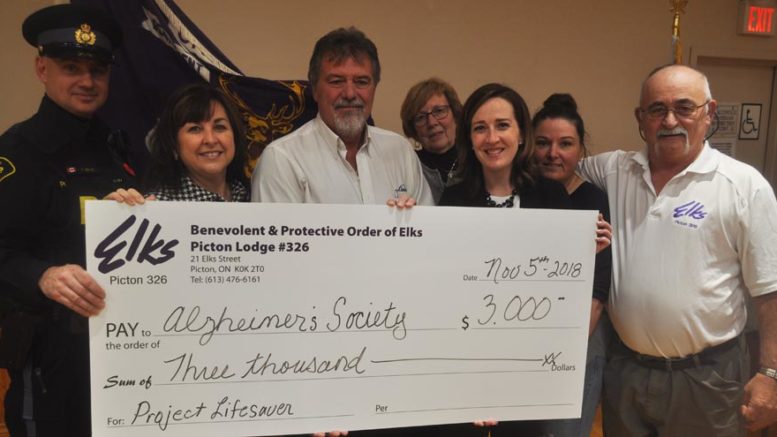 <p>Safety First – From left: OPP Const. Paul Leblanc, Alzheimer Society executive director Maureen Corrigan, Picton Elks president Steve Milligan, Mary Everall,  Alzheimer Society fund development co-ordinator Morgan Haviland, Lisa Zachariah and Picton Elks past exalted Rick Wilkinson at the presentation of $3,000 for Project Lifesaver and Finding Your Way educational programming Monday. (Adam Bramburger/Gazette staff)</p>
