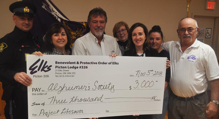 <p>Safety First – From left: OPP Const. Paul Leblanc, Alzheimer Society executive director Maureen Corrigan, Picton Elks president Steve Milligan, Mary Everall,  Alzheimer Society fund development co-ordinator Morgan Haviland, Lisa Zachariah and Picton Elks past exalted Rick Wilkinson at the presentation of $3,000 for Project Lifesaver and Finding Your Way educational programming Monday. (Adam Bramburger/Gazette staff)</p>
