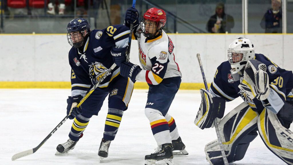 <p>UNDER SIEGE- Dukes forward Elijah Gonsalves battles with Whitby Fury defender Reid Webster as net minder Luke Pearson looks to the puck during the first period of Wellington’s 3-2 loss Friday night at Lehigh Arena.<br />
(Photo by Ed McPherson / OJHL Images)</p>
