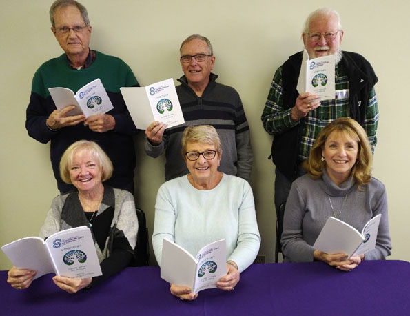 <p>Updated directories -Members of the Prince Edward County Community Care for Seniors Association board of directors peruse the latest edition of their annual resource directory. (Submitted photo)</p>
