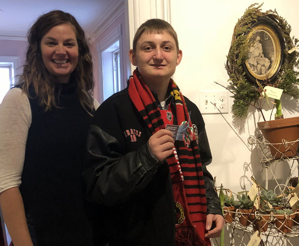 <p>Stamping it out – Caitlin O’Reilly joins County Advocate Hudson Yarrow as  hands out cards at the House of Falconer encouraging people to be conscious of their words and to choose inclusive, respectful language. (Submitted photo)</p>
