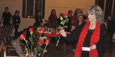 <p>Tribute – Participants in a candlelight vigil at St.Andrew’s Presbyterian Church Dec. 6 laid roses in memory of victims of violence against women. (Adam Bramburger/Gazette staff)</p>
