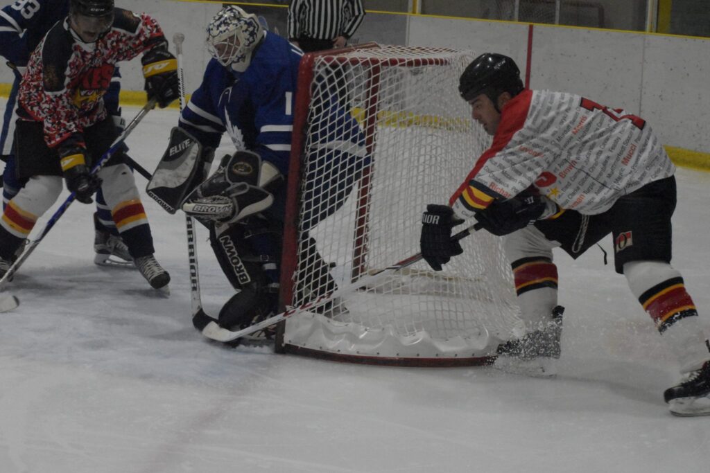 <p>Wellington Dukes alum Jordan Freeland tries to sneak a wrap around attempt past Toronto Maple Leafs Alumni netminder Mark Laforest. (Jason Parks/Gazette Staff)</p>
