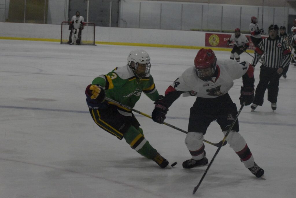 <p>GETTING BY- Picton Pirate Logan White slips past Amherstview defenceman Jack Wiley during Picton’s 10-4 win on Thursday night at Huff Estates Arena. (Jason Parks/Gazette Staff)</p>
