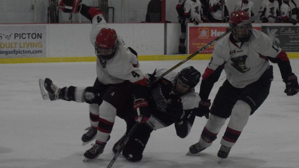 <p>CRASH AND BANG- PIcton Pirate defenceman Kurtis Wood sends Napanee’s Jacob Gilbert flying in the club’s 1-0 home ice win over the Raiders Thursday night at Huff Estates Arena. (Jason Parks/Gazette Staff)</p>
