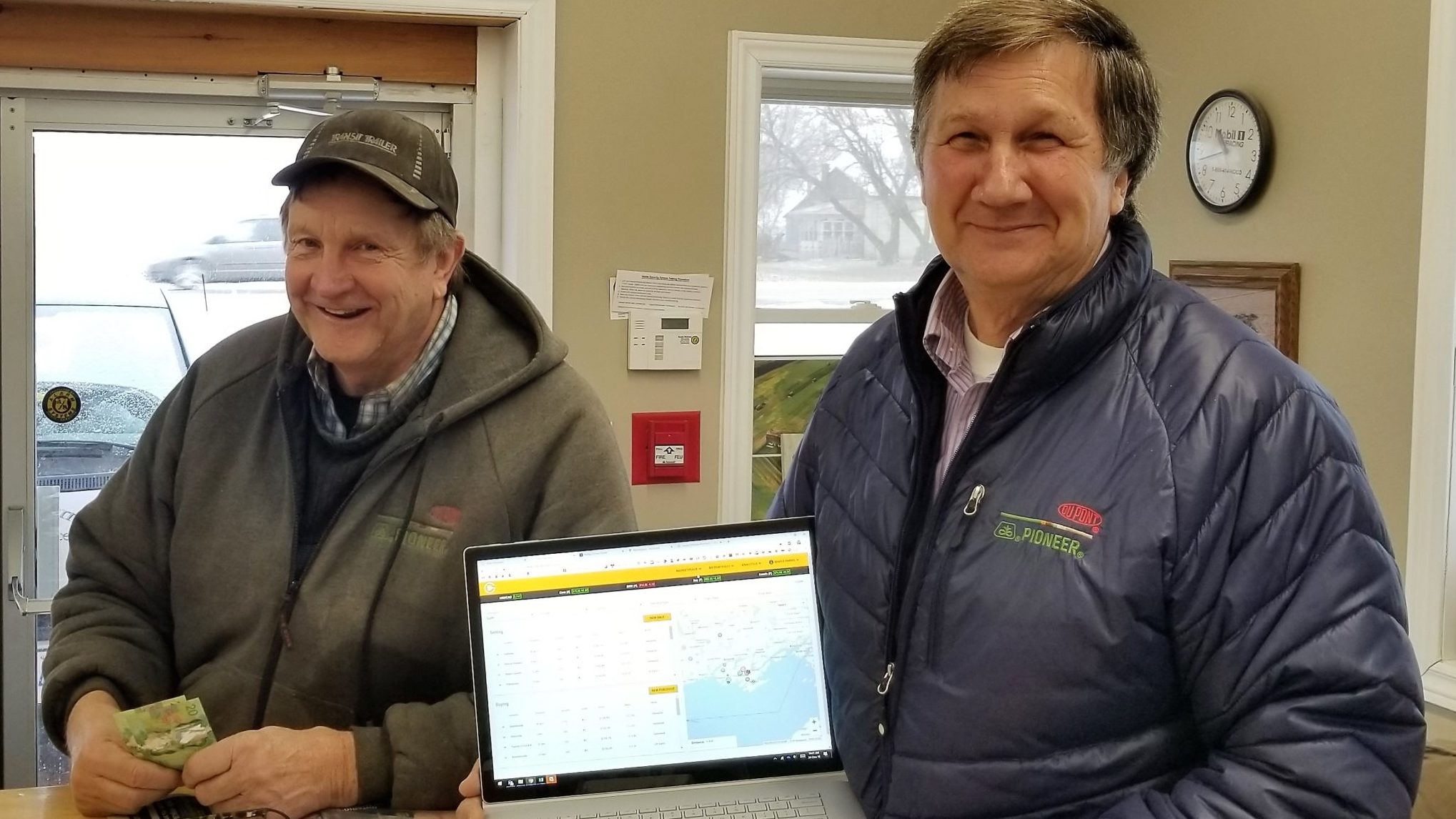 <p>A NEW DISCOVERY- (From left) Larry Reynolds and Lloyd Crowe of Reynolds Farms used Grain Discovery to sell a load of corn in late December, a first for the online application that was developed in part by a local man. (Submitted Photo)</p>

