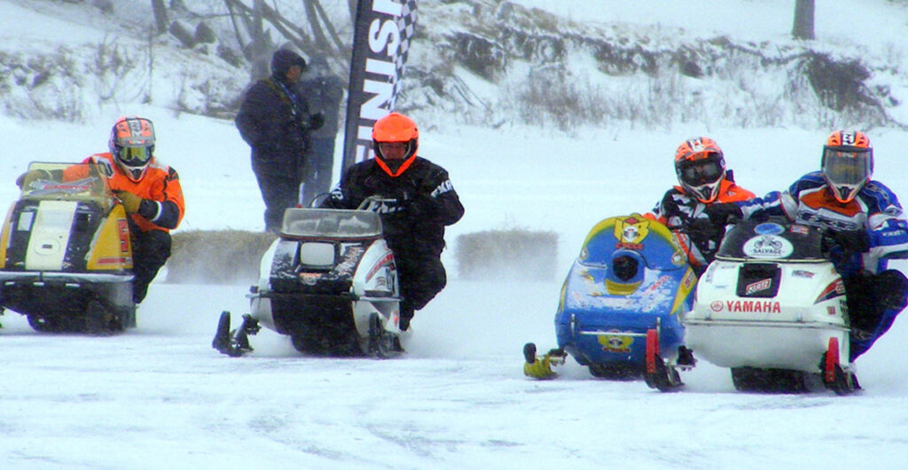 <p>Ready to roar – A group of racers approach the start line  as they get ready to compete in during the Sand Dunes Cup, a series of races run by the Ontario Snowmobile Oval Racers on the ice at the Isaiah Tubbs Resort and Conference Centre on Saturday. Organizers had planned for two days of racing on West Lake, but extreme cold and high winds led them to cancel Sunday’s competition. (Terry McNamee/For The Gazette)</p>

