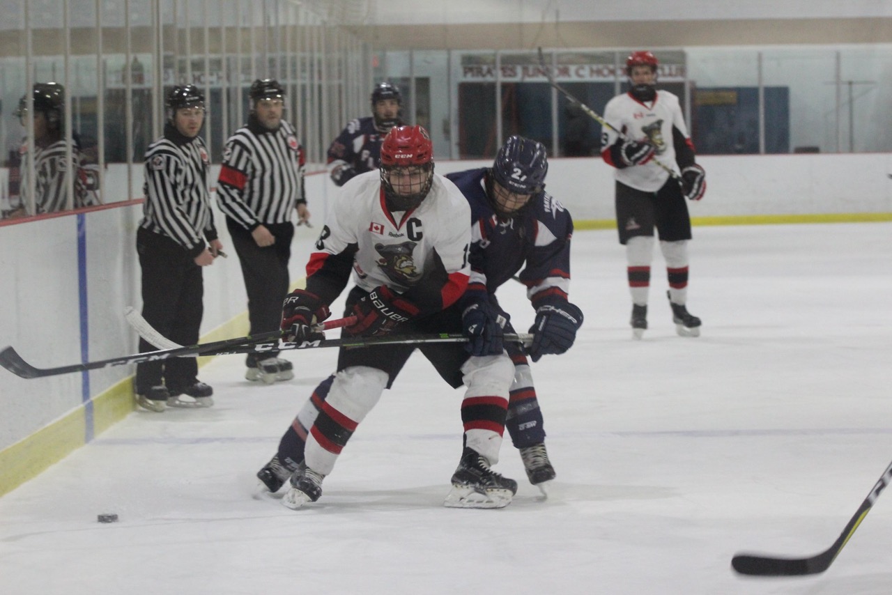 <p>PIRATES POWER PAST PANTHERS- Picton Pirates capitan Devin Morrison tires to  control the puck while being checked by Port Hope Panther Thomas Wunderlich. Picton beat the visitors 2-1. (Heather Johns for the Gazette)</p>
