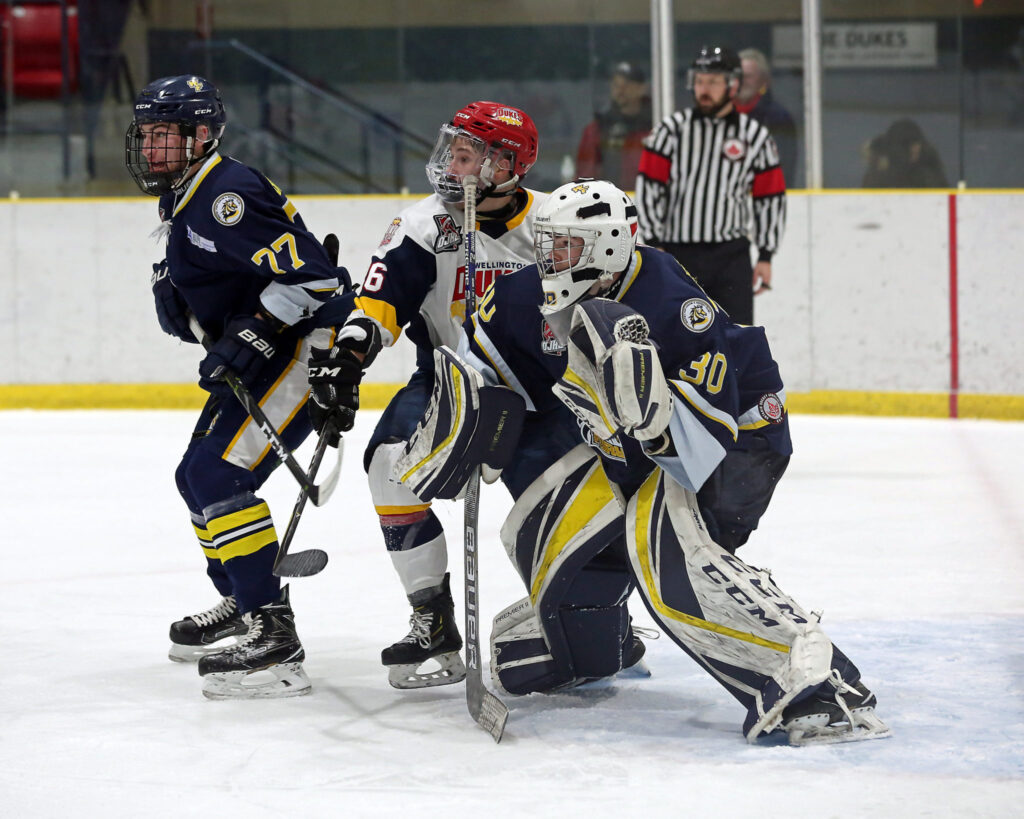 <p>FURIOUS ACTION- Wellington’s Ben Woodhouse and Whitby defender Dakota Betts jostle in front of net minder Luke Pearson during a game in 2018-19.<br />
(Photo by Ed McPherson / OJHL Images)</p>
