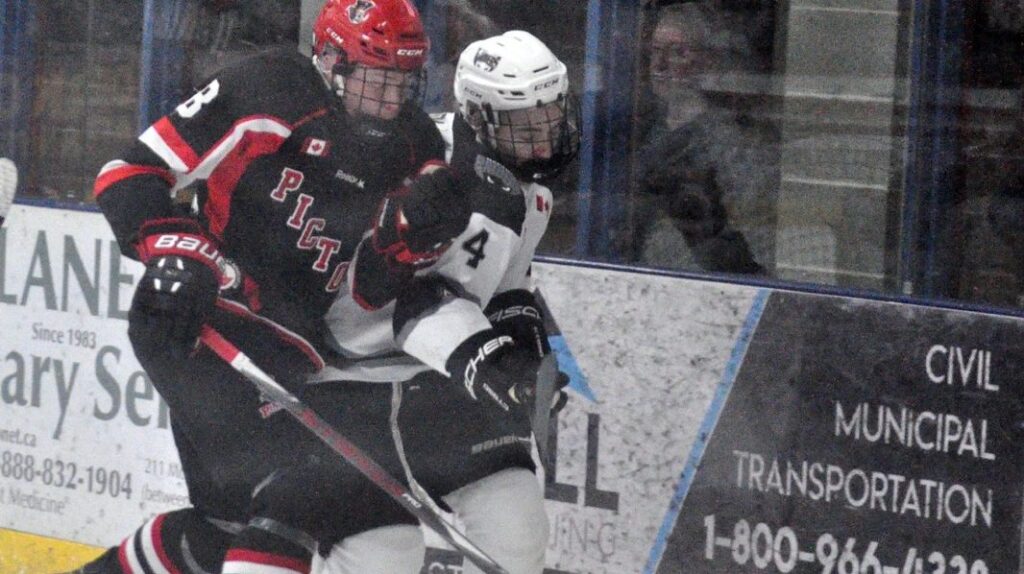 <p>CRUNCH TIME- Picton’s Noah Brant plays a physical role in trying to beat Raider Curtis Marrison to the puck in Picton’s 4-3 win  over host Napanee Friday. (Adam Bramburger/Gazette Staff)</p>
