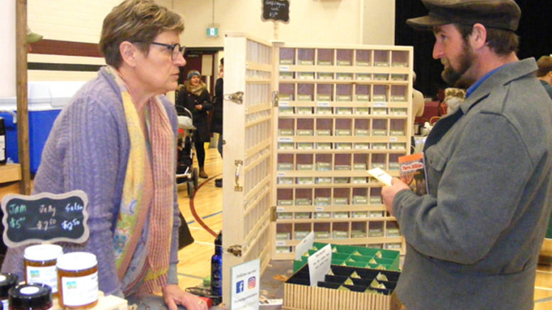 <p>Planting seeds – Lorraine Schmid of Carrying Place represented her Thyme Again Gardens during Seedy Saturday at PECI on Saturday. Here she is chatting with Warkworth resident and mushroom grower Derik Greenly. More than 30 vendors participated. (Terry McNamee/For The Gazette)</p>
