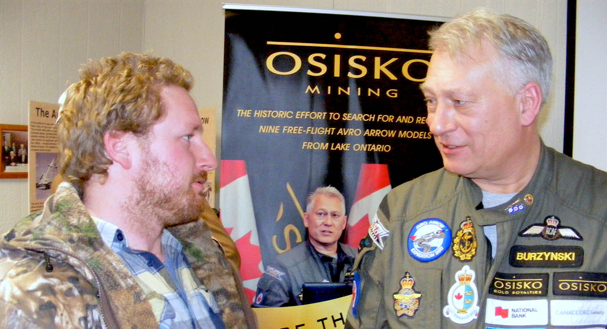 <p>Expedition interest – Aaron Snyder of Foxboro (left) talks with John Burzynski, CEO of Osisko Mining and the man leading the search for the lost models of the Avro Arrow aircraft, following a talk called “Raising the Arrow” at Milford Town Hall on Sunday. (Terry McNamee/For The Gazette)</p>
