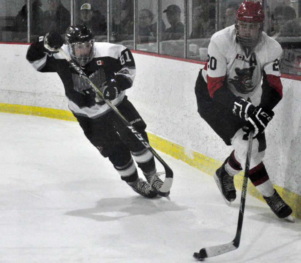 <p>Pirates defenceman Matthew Scott tries to evade Keegan Wayte during Picton’s 5-4 overtime win against Napanee on Thursday.<br />
(Adam Bramburger/Gazette Staff)</p>
