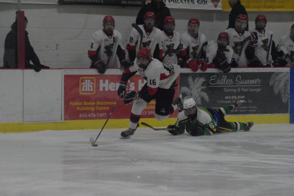 <p>STEPPING ON BY- Picton Pirate Justin Arnold gets past a diving Tyler Huffman during the second period of his team’s 8-3 win over the Amherstview Jets on Thursday night. (Jason Parks/Gazette Staff)</p>

