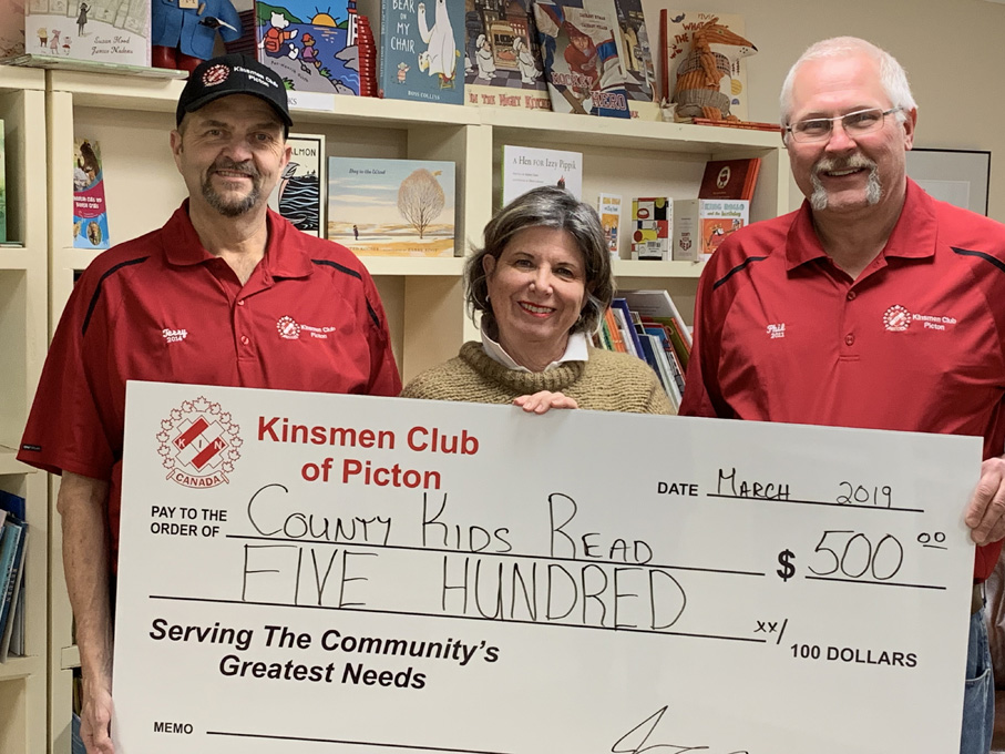 <p>Kinsmen Club of Picton vice-president Terry Miller, left, and treasurer Phil St. Jean present County Kids Read co-ordinator Anne Preston a $500 donation to support the children’s literacy program. (Submitted photo)</p>
