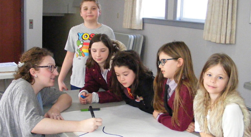 <p>Mapping it out  – Library staffer Jule Lane, left, draws a map with workshop  participants (from left) Shawn Colvin, Mikayla Colvin, Ember Landucci, Blythe Everhardus and Sophia Myderwyk. (Terry McNamee/For The Gazette)</p>

