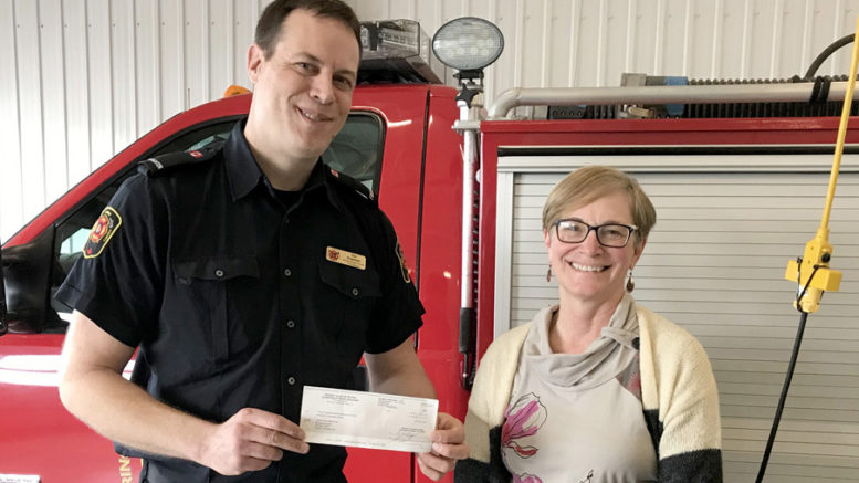 <p>The Rotary  Club of Picton recently enjoyed a tour of the Picton fire hall, led by full-time firefighter Tim Kraemer. Here, Kraemer accepts a donation of $1,017 from club president Brenda Hellyer to  support the fire department’s public safety education programming. (Peggy de Witt photo)</p>
