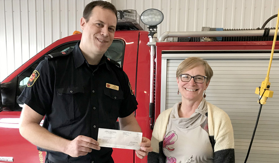 <p>The Rotary  Club of Picton recently enjoyed a tour of the Picton fire hall, led by full-time firefighter Tim Kraemer. Here, Kraemer accepts a donation of $1,017 from club president Brenda Hellyer to  support the fire department’s public safety education programming. (Peggy de Witt photo)</p>
