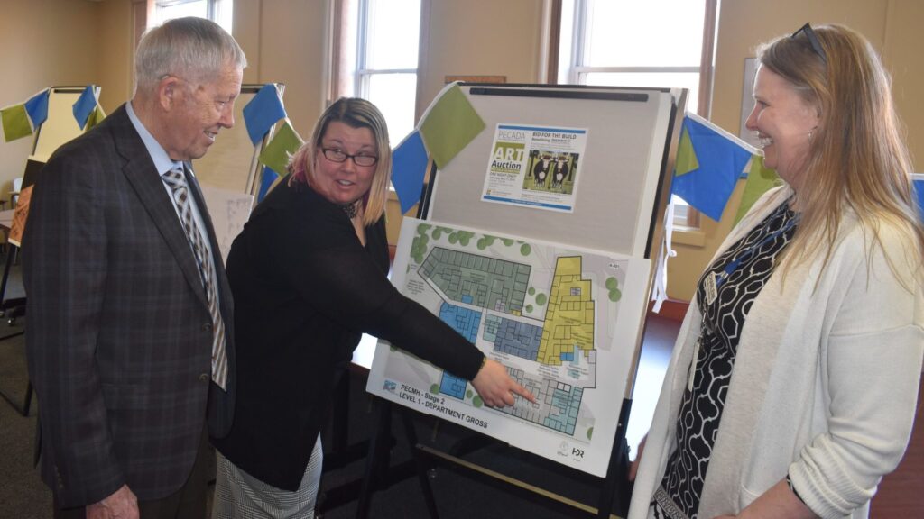 <p>A NEW DAY DAWNING- (From left) Inaugural Prince Edward County Memorial Foundation Chair Don Stanton Sr. is shown plans of the proposed redeveloped PECMH by Foundation communications person Briar Boyce and QHC Project Coordinator Charlene Jackson at the celebration of the 100th anniversary of the opening the county’s original hospital on Hill Street on Wednesday. (Jason Parks/Gazette Staff)</p>
