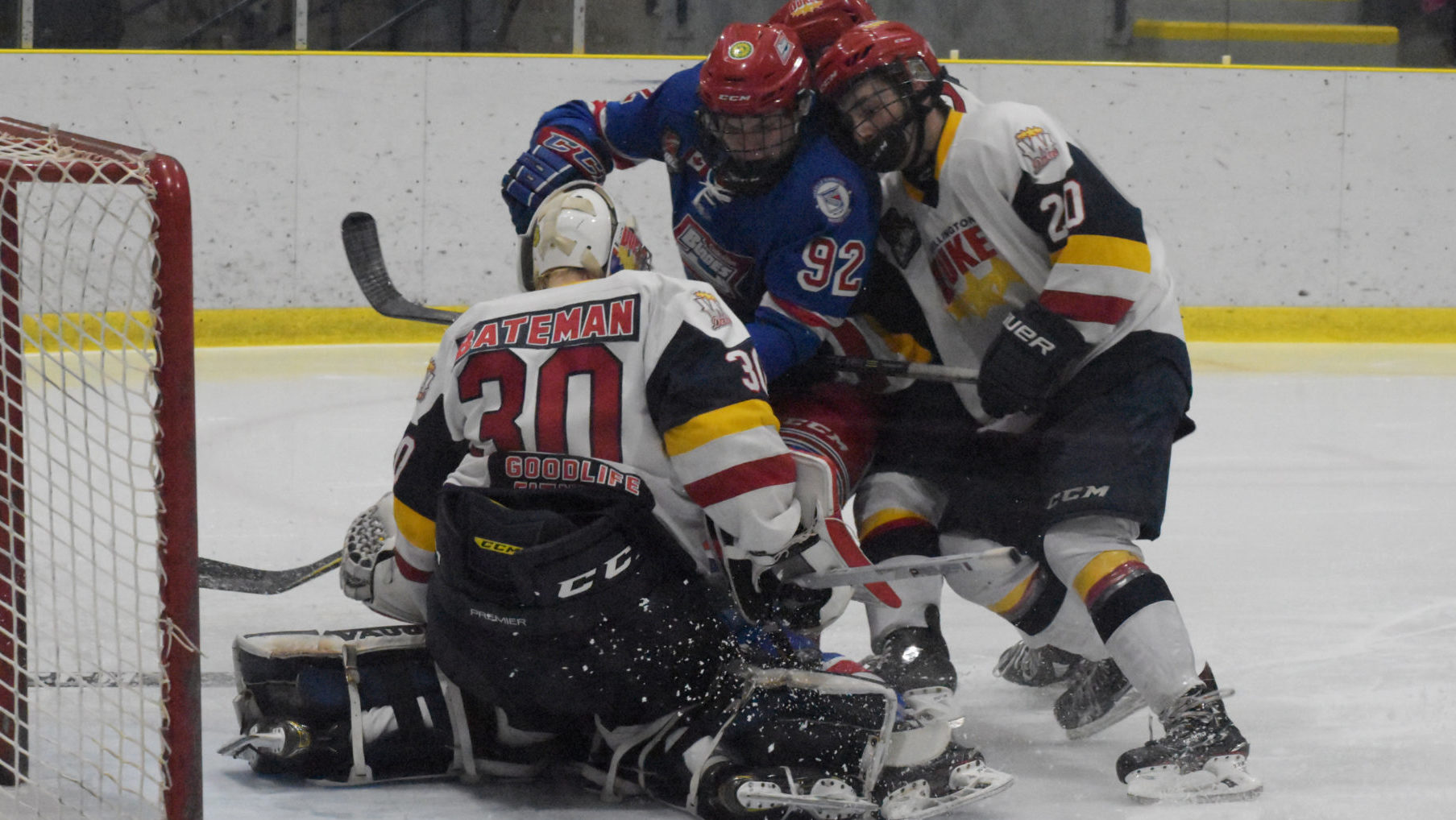 <p>HEAD-TO-HEAD- Wellington goalie Logan Bateman holds his crease as Oakville Blade Kyle Potts and Dukes defenceman Ben Addison crash the crease during Game 4 of the OJHL Buckland Cup finals at Lehigh Arena Thursday night. (Jason Parks/Gazette Staff)</p>
