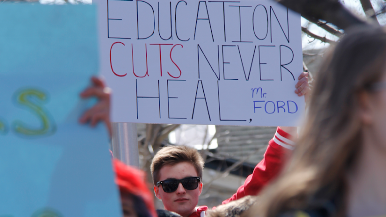 <p>A PECI Student holds a sign at a student organized protest at Picton’s cenotaph on Thursday afternoon. (Desirée Decoste/For the Gazette)</p>
