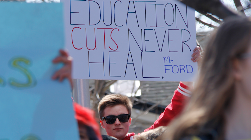 <p>A PECI Student holds a sign at a student organized protest at Picton’s cenotaph on Thursday afternoon. (Desirée Decoste/For the Gazette)</p>
