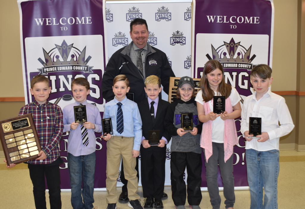 <p>Don Wight Memorial Award winning coach of the year Chad Camp joins Novice County Farm Centre BB Kings standouts (from left) Gilbert Graham, Weston Byford, Landon Latchford, Caleb Krentz, Blake Shephard-Benway, Avery Cole and Easton Vanhecke at the Prince Edward County Minor Hockey association awards night at Highline Hall on Tuesday. (Jason Parks/Gazette Staff)</p>
