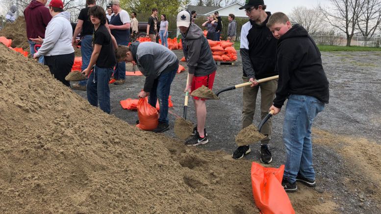<p>PECI students work shovels and sandbags at the Johnson St. soccer pitch parking lot. Last year, secondary school students pitched in and filled sandbags for shoreline residents who are unable to fill their own sandbags at the stations throughout Prince Edward County. (Jason Parks/Gazette Staff)</p>
