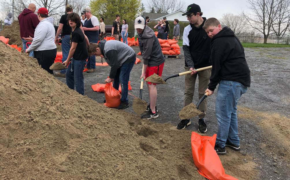 <p>PECI students work shovels and sandbags at the Johnson St. soccer pitch parking lot. Last year, secondary school students pitched in and filled sandbags for shoreline residents who are unable to fill their own sandbags at the stations throughout Prince Edward County. (Jason Parks/Gazette Staff)</p>
