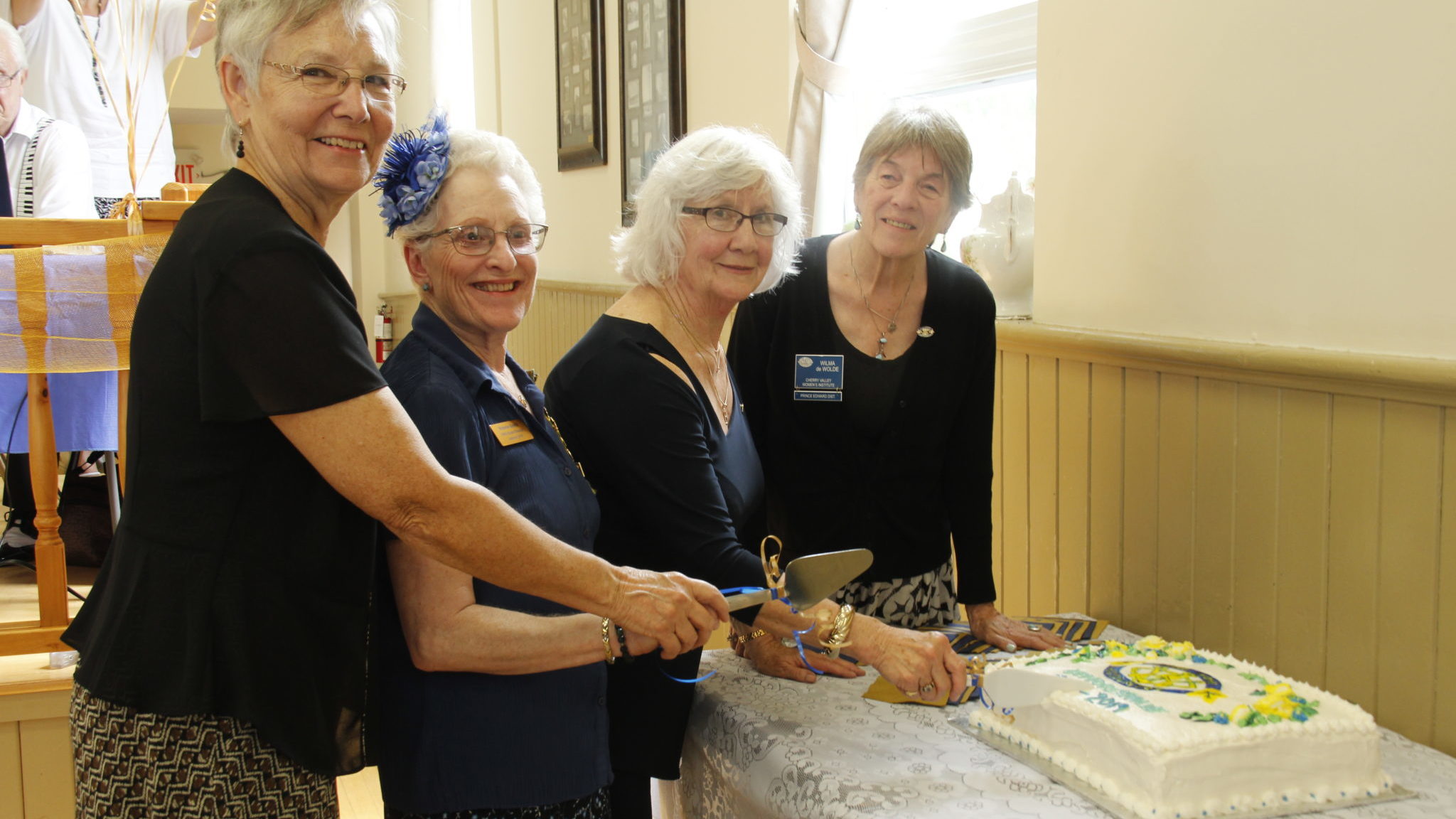 <p>A CENTURY IN THE MAKING (left to right) Mary Shortt past president, Valerie Smith board director, Barbara Foster President of DWI and Wilma DeWolde PEC district WI president all took part in cutting the 100th anniversary cake at Sophiasburgh Town Hall. About 100 people attended the anniversary celebrations. (Desirée Decoste/Gazette Staff)</p>
